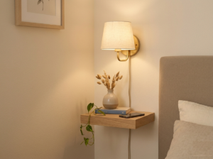 plug-in wall sconce above corner bed replacing nightstand lamp in small bedroom
